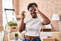 African american woman holding keys of new home smiling happy doing ok sign with hand on eye looking through fingers Royalty Free Stock Photo