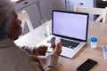 African american woman holding medication container having a video call on laptop with copy space Royalty Free Stock Photo