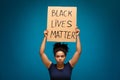 African american woman holding placard Black lives matter