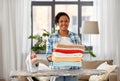African american woman with ironed linen at home