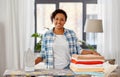 African american woman with ironed linen at home