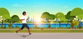 African american woman jogging outdoors modern public park girl headphones running sport activity concept cityscape