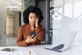 Young woman receives upsetting news on her phone in office Royalty Free Stock Photo