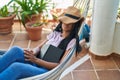 African american woman lying on hammock sleeping at home terrace Royalty Free Stock Photo