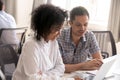 African American woman and male colleague discussing online project Royalty Free Stock Photo