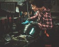 African american woman mechanic polishing motorcycle fuel tank