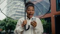 African American woman mobile phone smartphone businesswoman female girl rain umbrella outdoors entrepreneur employee