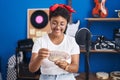 African american woman musician smiling confident counting dollars at music studio Royalty Free Stock Photo