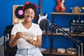 African american woman musician smiling confident counting dollars at music studio Royalty Free Stock Photo