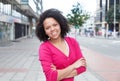 African american woman in pink shirt with crossed arms in the city Royalty Free Stock Photo