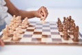 African american woman playing chess game sitting on table at home Royalty Free Stock Photo