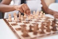 African american woman playing chess game sitting on table at home Royalty Free Stock Photo