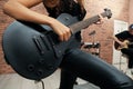 African American woman playing electric guitar during rehearsal in studio, closeup. Music band practice Royalty Free Stock Photo