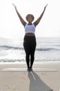 African American woman practicing yoga at the beach Royalty Free Stock Photo