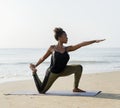 African American woman practicing yoga at the beach Royalty Free Stock Photo