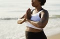 African American woman practicing yoga at the beach Royalty Free Stock Photo