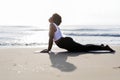 African American woman practicing yoga at the beach Royalty Free Stock Photo