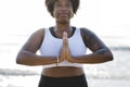 African American woman practicing yoga at the beach Royalty Free Stock Photo