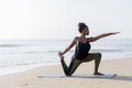 African American woman practicing yoga at the beach Royalty Free Stock Photo