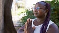 African american woman praying with closed eyes at park Royalty Free Stock Photo