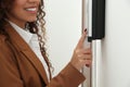 African-American woman pushing intercom button in entryway, closeup Royalty Free Stock Photo