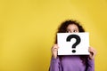 African-American woman with question mark sign on background. Space for text Royalty Free Stock Photo