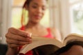 African American Woman Reading Book At Home Focus On Hand Royalty Free Stock Photo