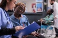 African american woman receiving instructions from physical therapist Royalty Free Stock Photo