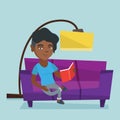 Young african woman reading a book on sofa.