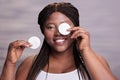 African american woman removing eyes makeup with cotton disks Royalty Free Stock Photo