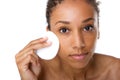 African american woman removing makeup with sponge