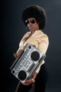 African American woman with retro look and a cassette tape player