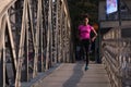 African american woman running across the bridge Royalty Free Stock Photo