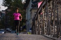 African american woman running across the bridge Royalty Free Stock Photo