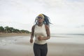 African American woman running on the beach - young attractive and athletic black girl training outdoors doing jogging workout at Royalty Free Stock Photo