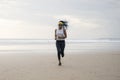 African American woman running on the beach - young attractive and athletic black girl training outdoors doing jogging workout at Royalty Free Stock Photo