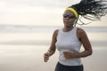 African American woman running on the beach - young attractive and athletic black girl training outdoors doing jogging workout at Royalty Free Stock Photo