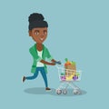 African woman running with a shopping cart.