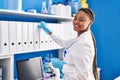African american woman scientist smiling confident holding binder at laboratory Royalty Free Stock Photo