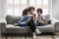 African american woman showing funny mobile application to children. Royalty Free Stock Photo