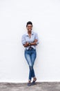 African american woman smiling against white wall Royalty Free Stock Photo