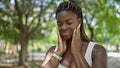 African american woman smiling confident touching face at park Royalty Free Stock Photo