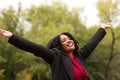 African American woman smiling with open arms.