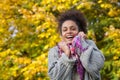 African american woman smiling with sweater and scarf in autumn Royalty Free Stock Photo