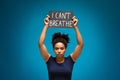 African american woman standing with banner I Can`t Breathe