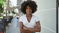 African american woman standing with serious expression and arms crossed gesture at street Royalty Free Stock Photo
