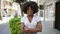 African american woman standing with serious expression and arms crossed gesture at street Royalty Free Stock Photo