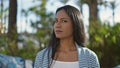 African american woman standing with serious expression at park Royalty Free Stock Photo