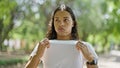 African american woman standing with serious expression sweating at park Royalty Free Stock Photo