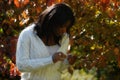 African-American woman staring at leaves